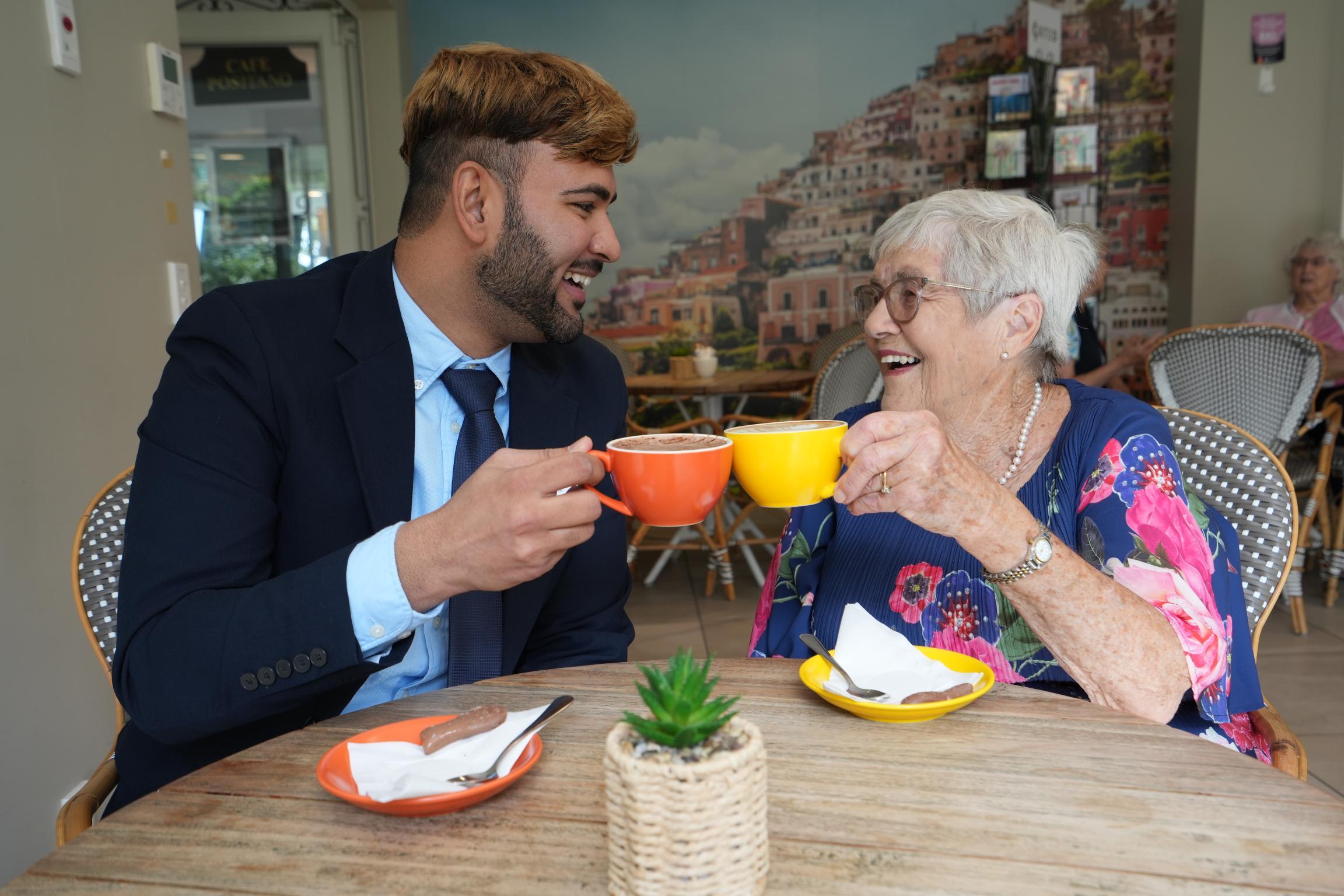 Village Manager Ruben Kumar with resident Margaret Arthur.
