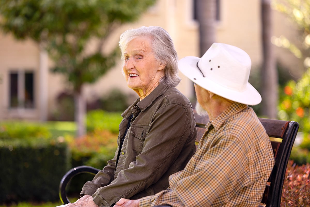 Elderly couple sitting outdoors together
