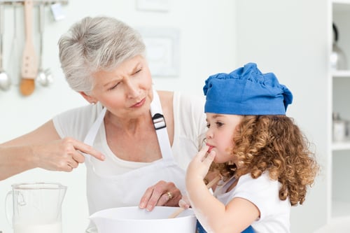 A little girl  baking with her grandmother at home