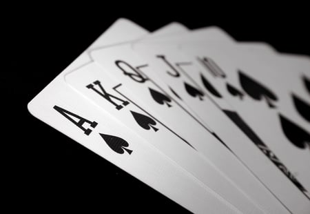 ace royal flush - spades over a black background