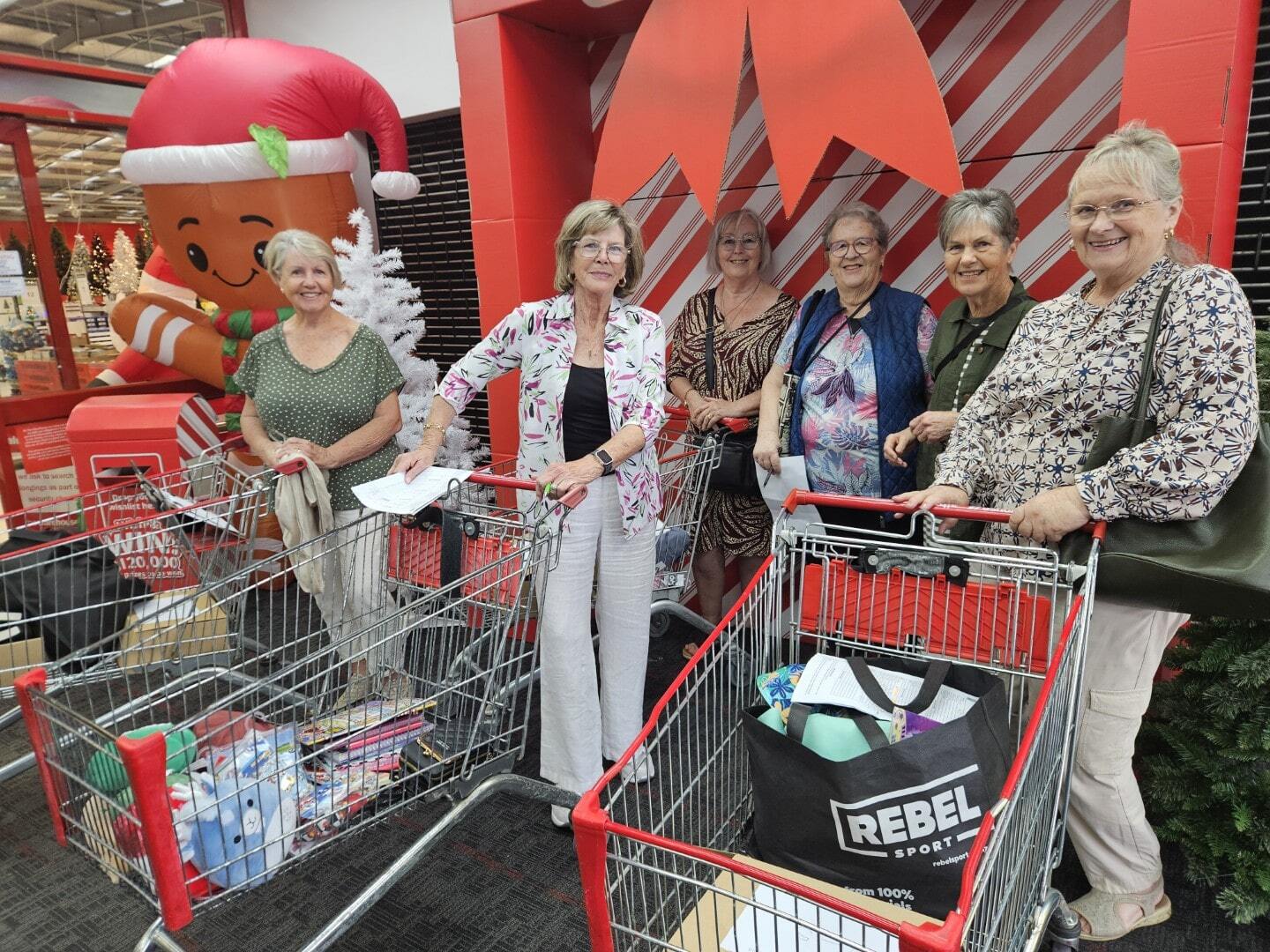 Older ladies smile on a festive shopping trip