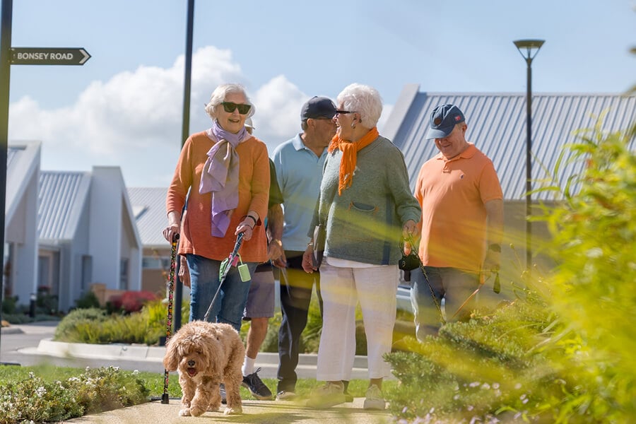 Ryman residents walking with dog in village