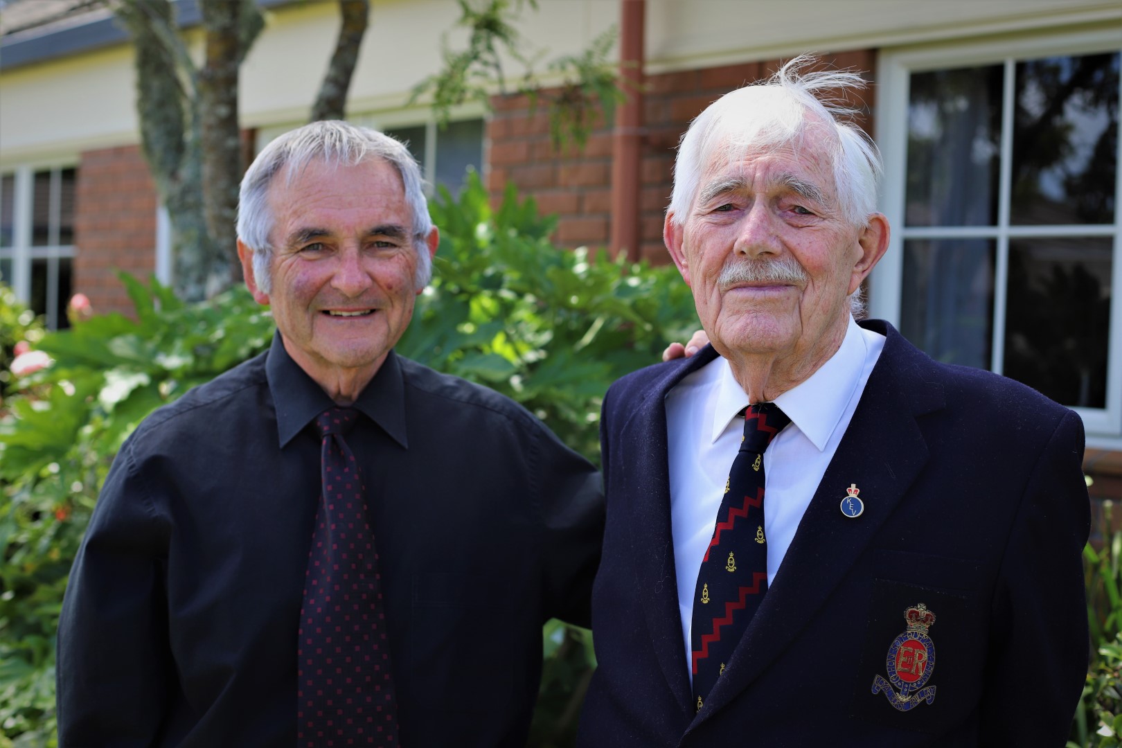 Father and son standing outside the retirement village