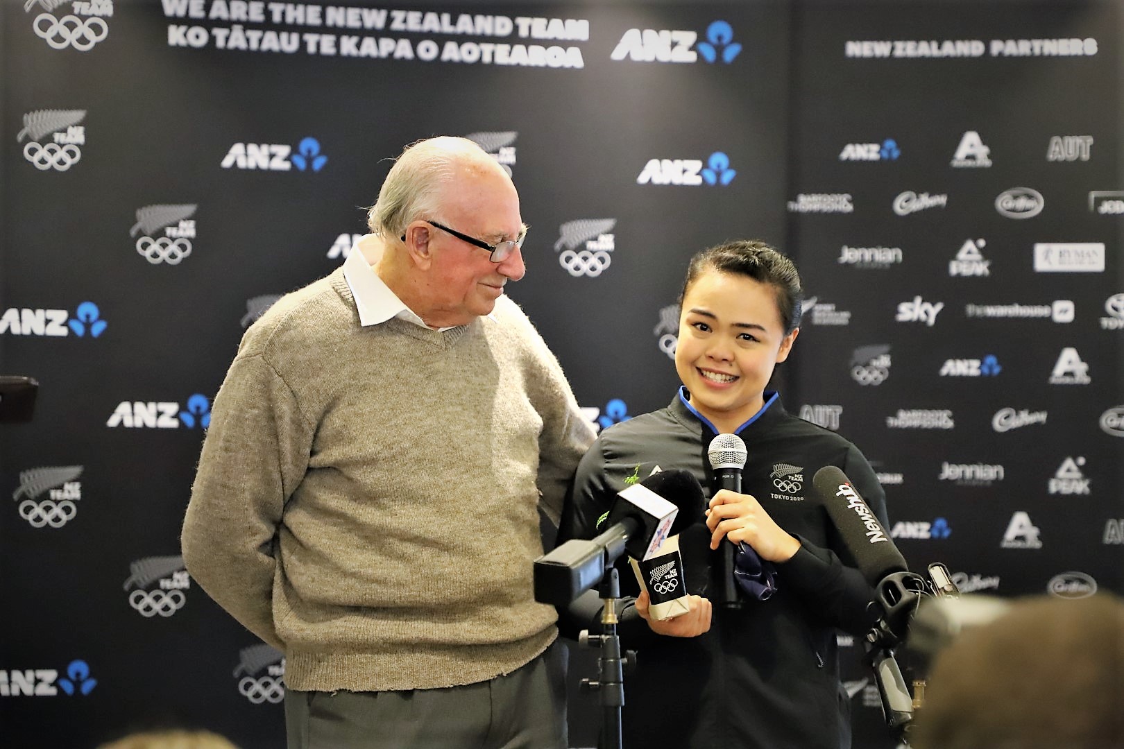 Olympians stand for a photo