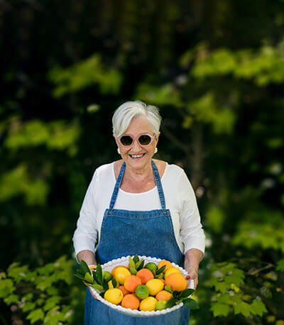 A resident holding a basket of fruit
