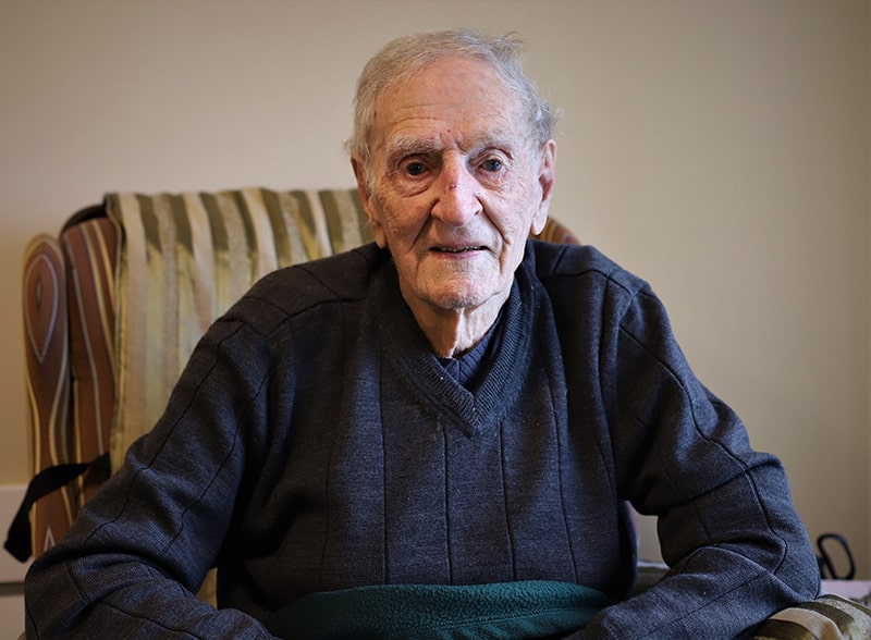 Scottish born resident sitting in his apartment