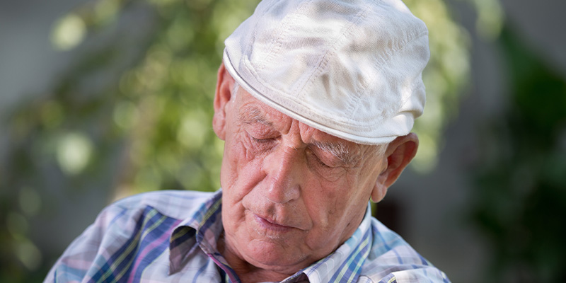 older man sleeping during the day